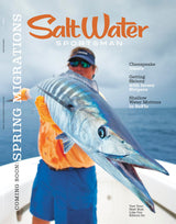 Magazine cover featuring a man holding a large fish with text about spring migrations and fishing topics.