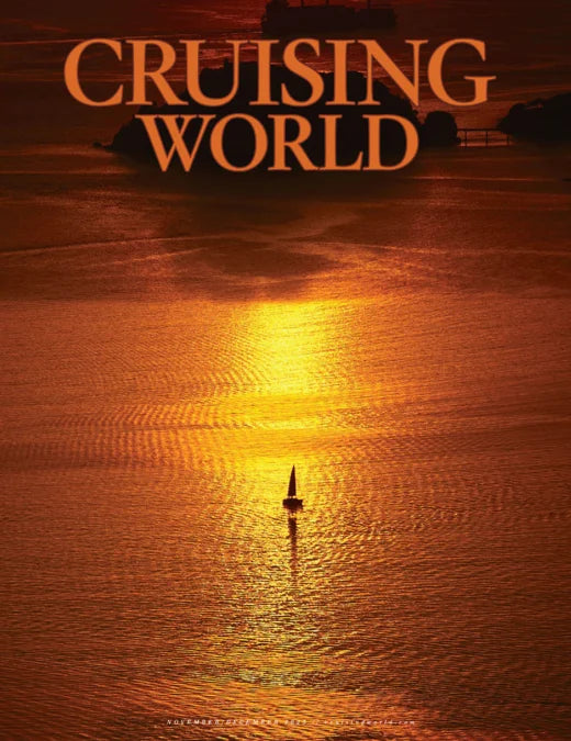 Sailing boat on water with sunset and 'Cruising World' text overlay