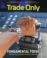 Magazine cover with a hand on a control panel and 'Trade Only' branding.